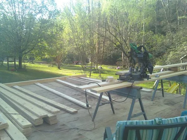 Miter saw and framing lumber on a deck under construction in Youngstown